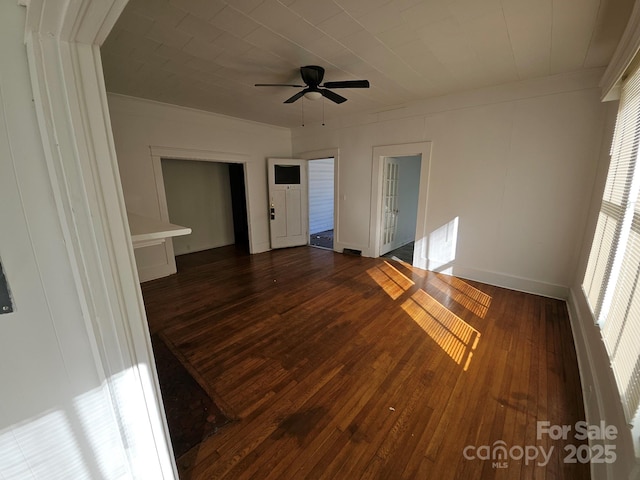 empty room with hardwood / wood-style floors, a ceiling fan, and crown molding