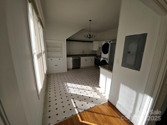 kitchen featuring dark countertops, dishwasher, electric panel, a notable chandelier, and white cabinetry