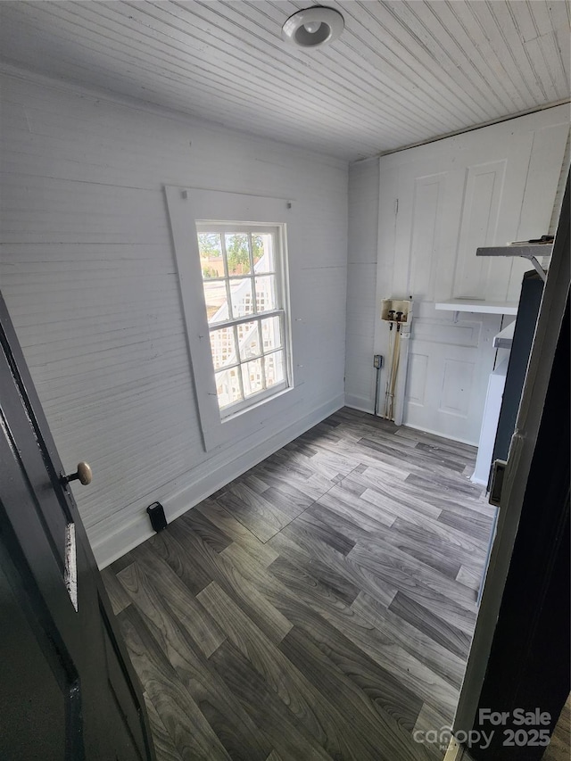 clothes washing area with dark wood finished floors, laundry area, and wooden ceiling