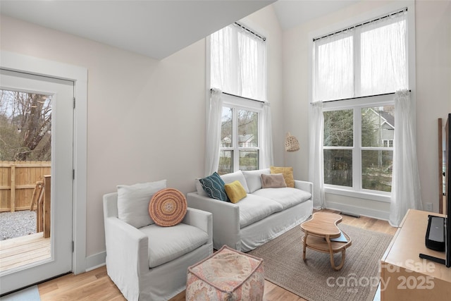 living room featuring light wood-style flooring and baseboards