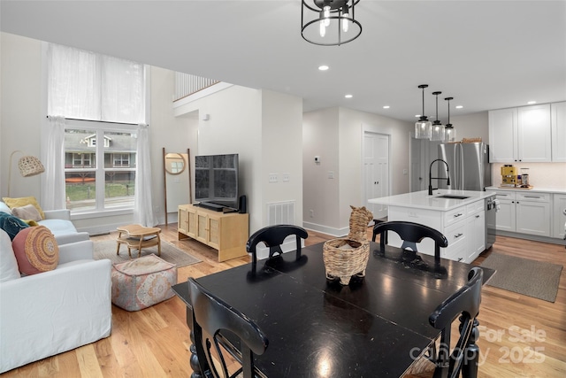 dining area featuring recessed lighting, light wood-style flooring, baseboards, and visible vents