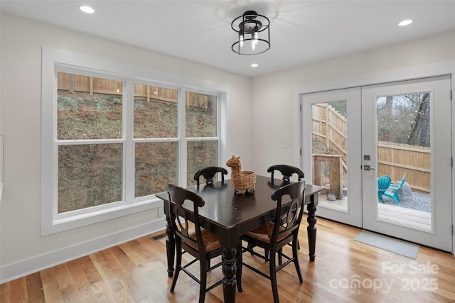 dining space with visible vents, light wood finished floors, baseboards, recessed lighting, and french doors