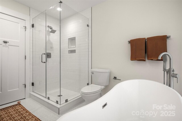 full bath featuring a shower stall, toilet, tile patterned floors, and a freestanding bath