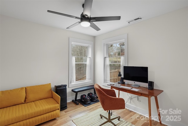 office area with visible vents, a ceiling fan, baseboards, and wood finished floors