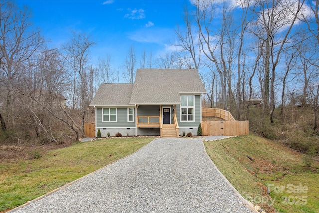 view of front of property featuring a porch, roof with shingles, a front yard, crawl space, and driveway