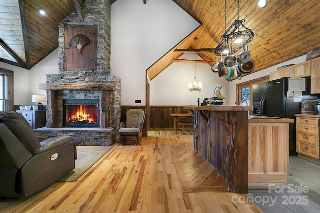 living room with high vaulted ceiling, a fireplace, and wood ceiling