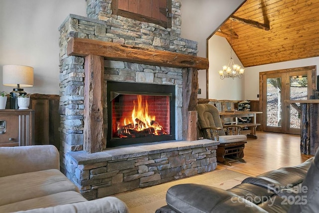 living area with high vaulted ceiling, wood ceiling, wood finished floors, and a fireplace