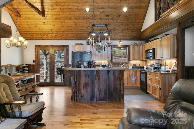 kitchen with french doors, black appliances, open floor plan, and wooden ceiling