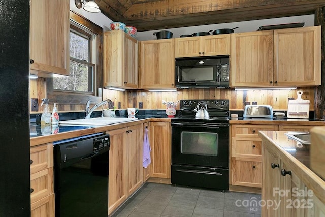 kitchen featuring a sink, black appliances, and light brown cabinetry