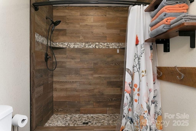 bathroom with tiled shower