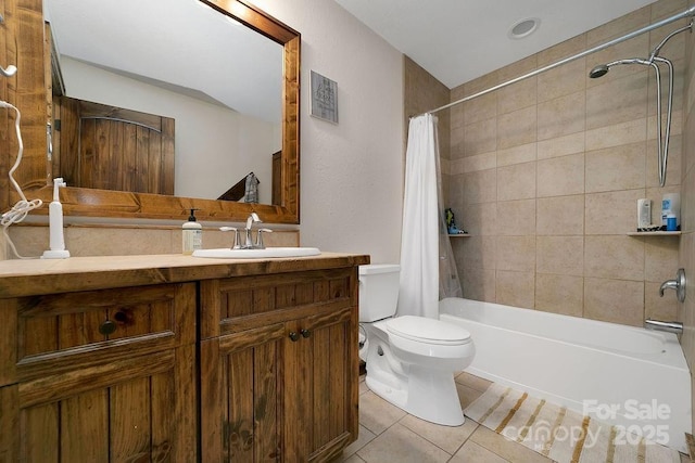 bathroom with vanity, tile patterned floors, toilet, and shower / tub combo with curtain