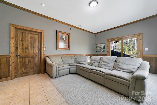 living room featuring visible vents, wainscoting, light tile patterned flooring, and crown molding