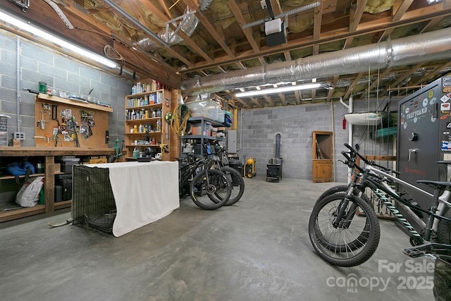 garage featuring a workshop area and concrete block wall