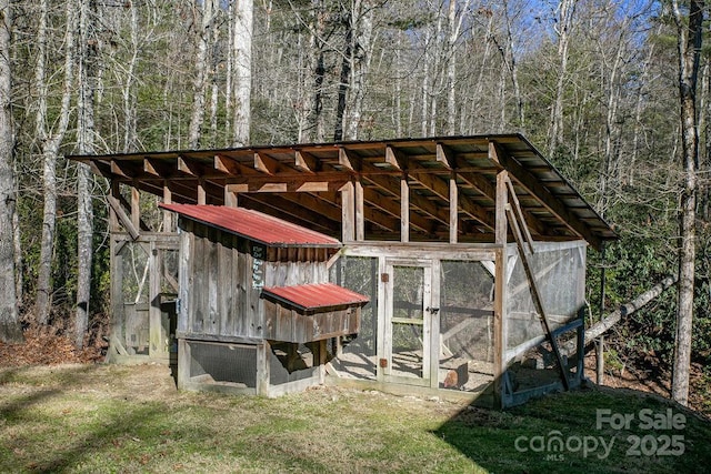 view of poultry coop with a view of trees