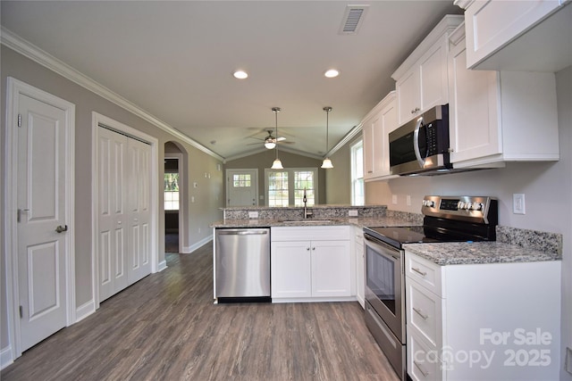 kitchen with a sink, visible vents, appliances with stainless steel finishes, and crown molding