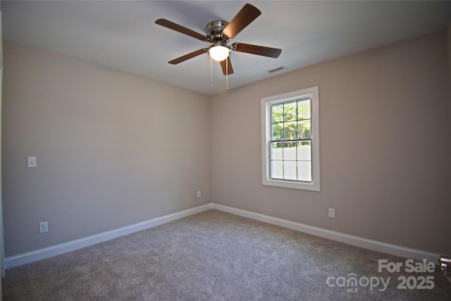 spare room featuring visible vents, carpet flooring, baseboards, and ceiling fan