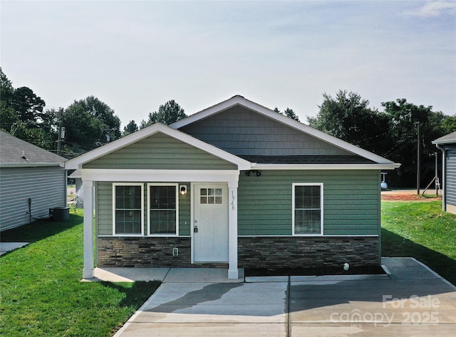 view of front of home featuring stone siding and a front lawn