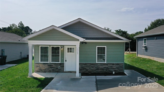 view of front of property featuring stone siding and a front yard