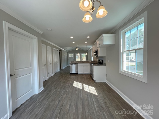 kitchen with dark wood-style floors, baseboards, ornamental molding, appliances with stainless steel finishes, and white cabinetry