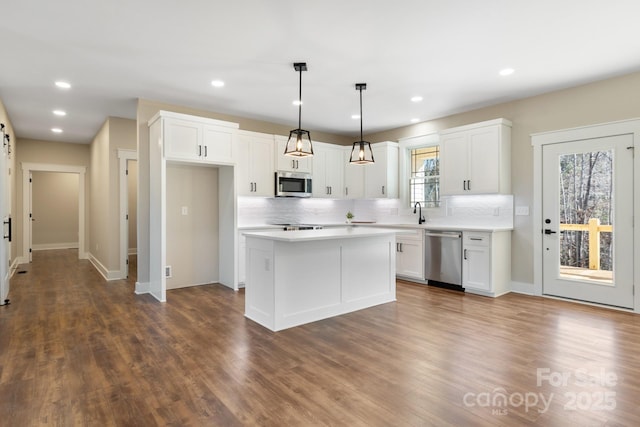 kitchen with white cabinetry, light countertops, and appliances with stainless steel finishes