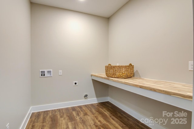 clothes washing area featuring electric dryer hookup, laundry area, baseboards, hookup for a washing machine, and dark wood-style flooring