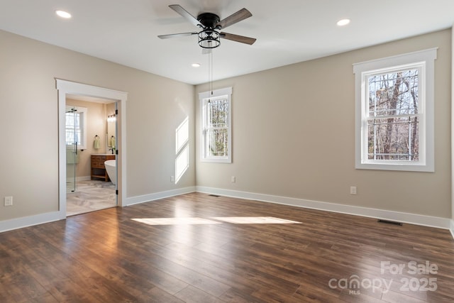 unfurnished bedroom with dark wood finished floors, visible vents, recessed lighting, and baseboards