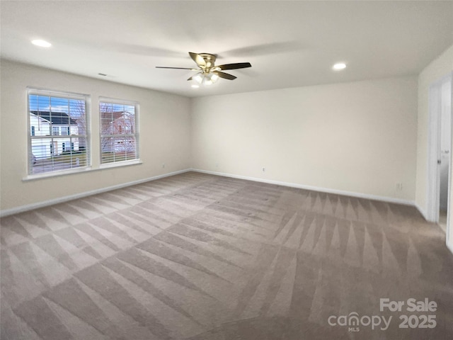 spare room with carpet flooring, recessed lighting, and baseboards