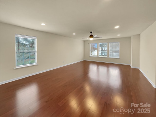 spare room with recessed lighting, baseboards, a ceiling fan, and dark wood-style flooring