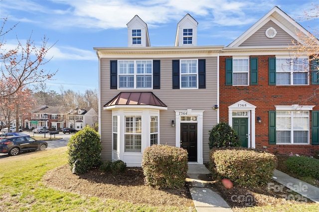 townhome / multi-family property with a standing seam roof