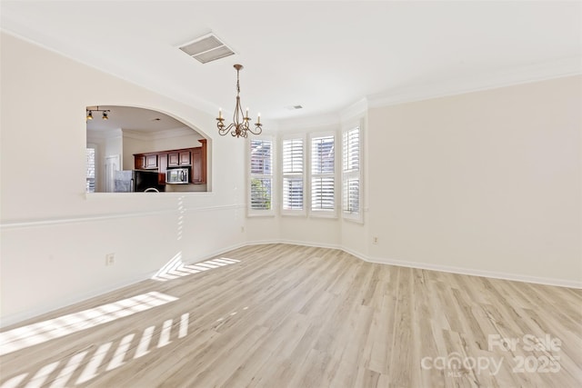 unfurnished room with light wood-type flooring, baseboards, visible vents, and ornamental molding