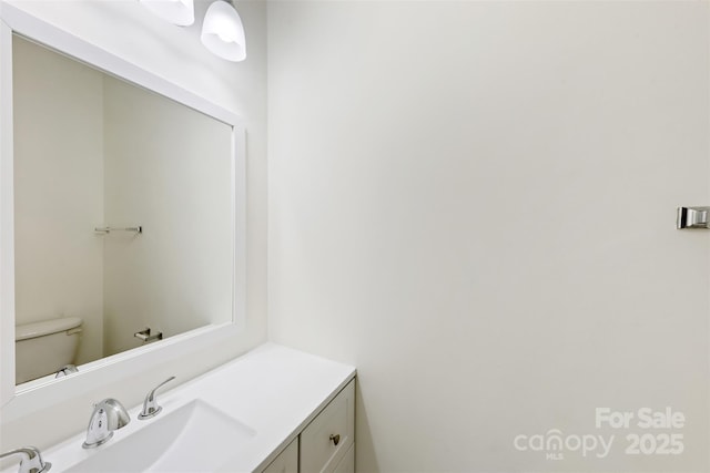 half bath with vanity and toilet