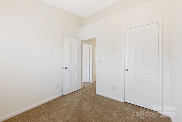 unfurnished bedroom with carpet and baseboards