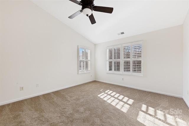 unfurnished room featuring a ceiling fan, baseboards, visible vents, carpet floors, and lofted ceiling