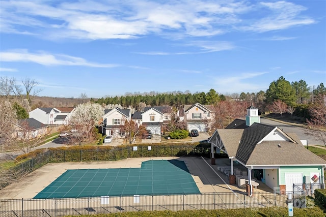 pool featuring a residential view, a patio, and fence