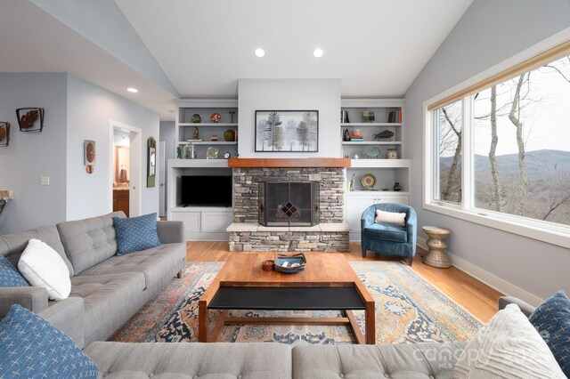 living room with baseboards, lofted ceiling, recessed lighting, a fireplace, and wood finished floors