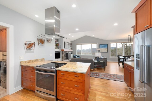 kitchen featuring stainless steel appliances, light wood-style floors, a peninsula, island range hood, and lofted ceiling