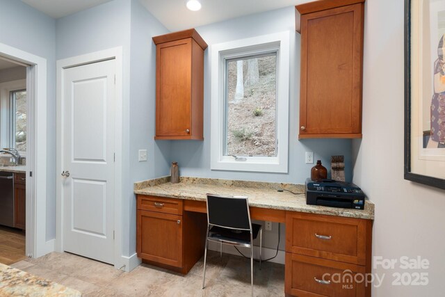 office area featuring baseboards and built in study area