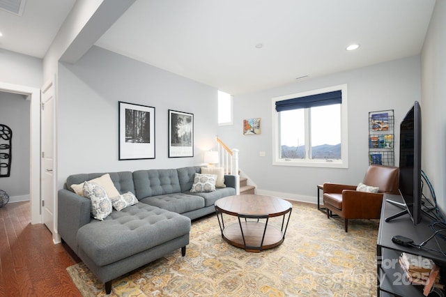 living area featuring visible vents, wood finished floors, recessed lighting, stairway, and baseboards