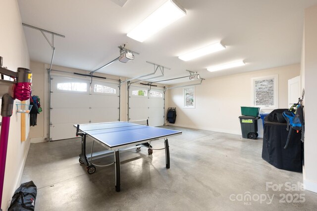 game room with a garage and finished concrete flooring