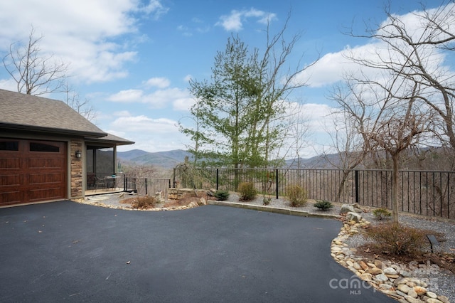 view of street featuring a mountain view and driveway