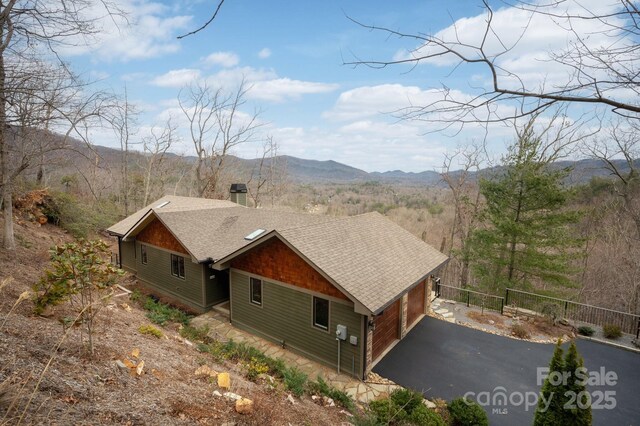 bird's eye view with a mountain view and a wooded view