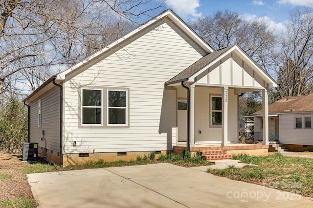 view of front facade featuring crawl space, central air condition unit, covered porch, and a shingled roof