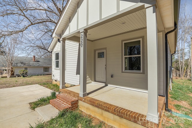 doorway to property featuring covered porch