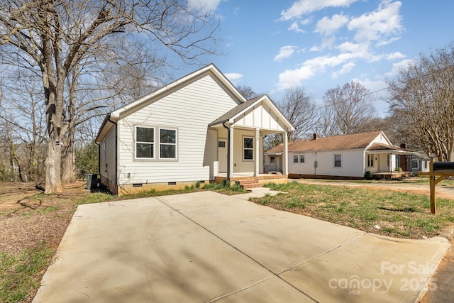 view of front of house featuring a porch, central AC unit, and crawl space