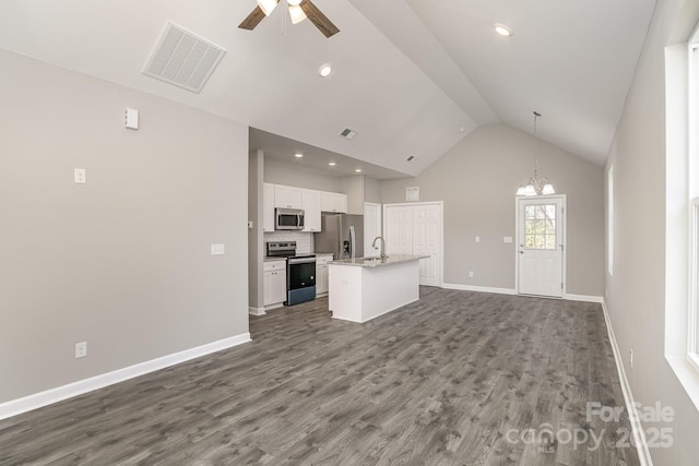 unfurnished living room featuring visible vents, baseboards, dark wood-style flooring, and ceiling fan with notable chandelier
