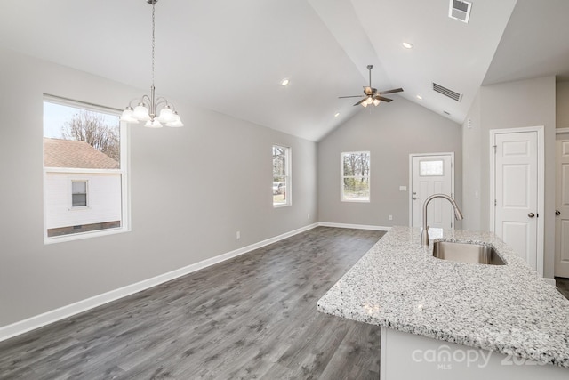 kitchen featuring dark wood-style floors, visible vents, baseboards, and a sink