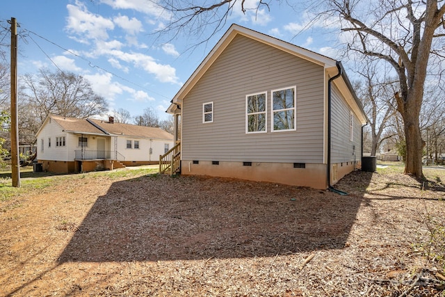 back of house featuring crawl space and central air condition unit