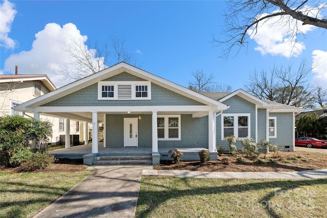 view of front of house featuring covered porch and a front yard