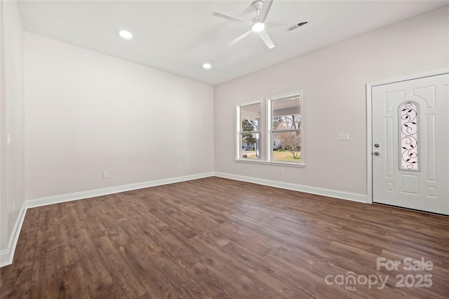 foyer entrance featuring dark wood finished floors, visible vents, baseboards, and ceiling fan