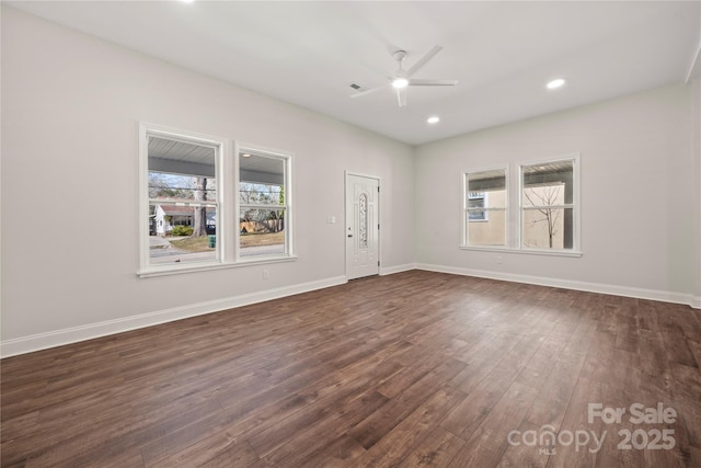 spare room featuring dark wood finished floors, recessed lighting, baseboards, and a ceiling fan